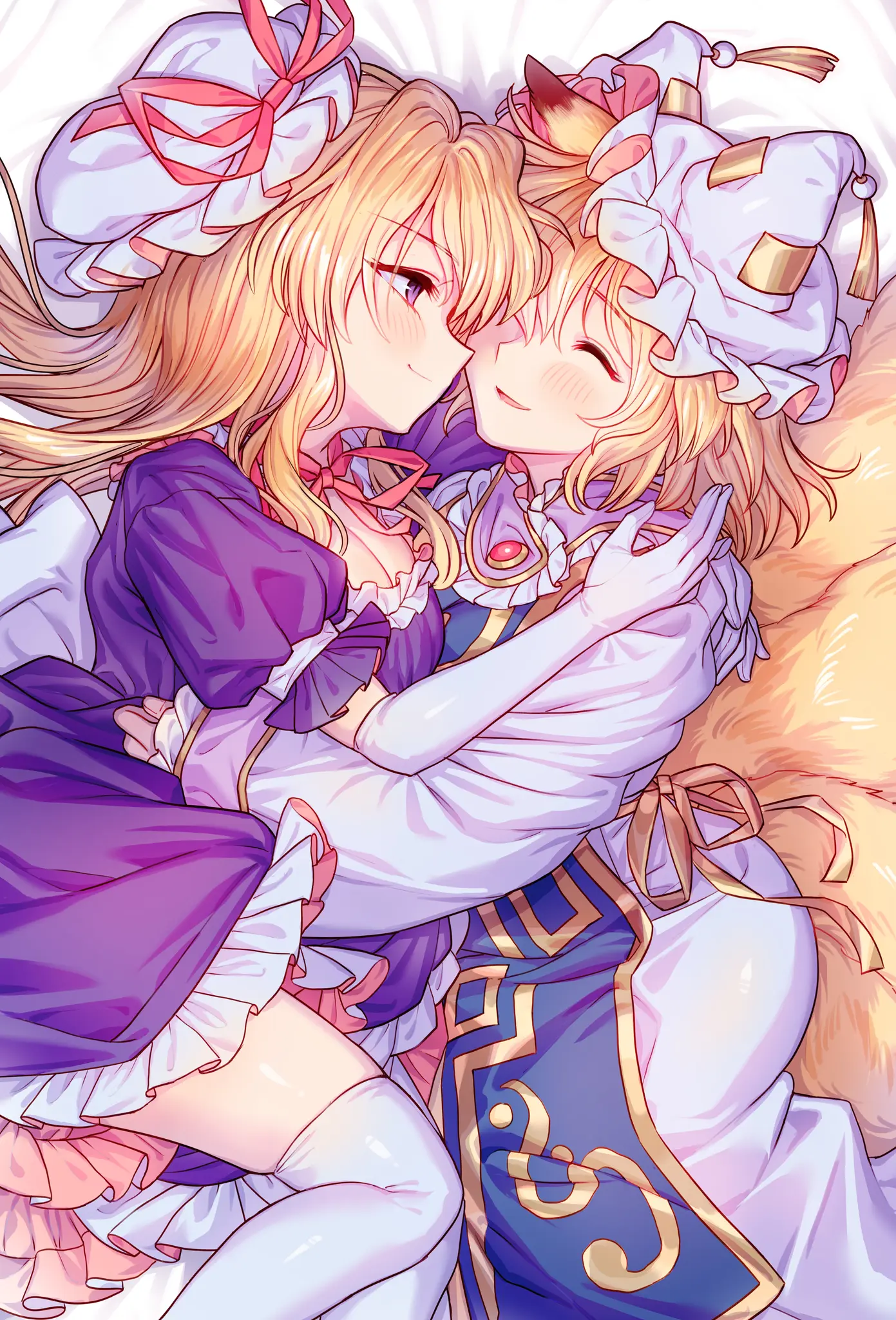 Girls hugging in bed.